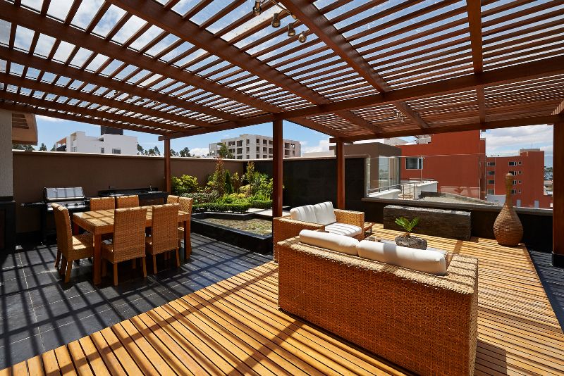 spacious timber decking with a dining table and chairs, and a lounge area