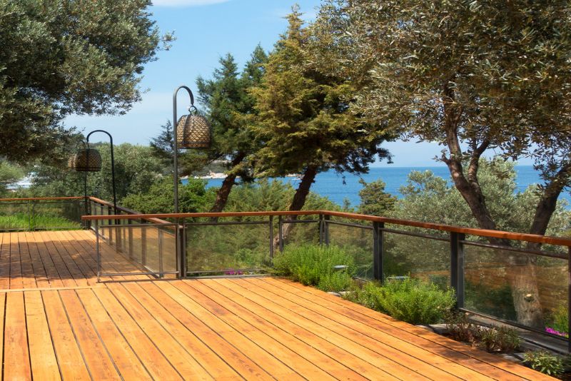 timber deck with glass railing and outdoor lighting